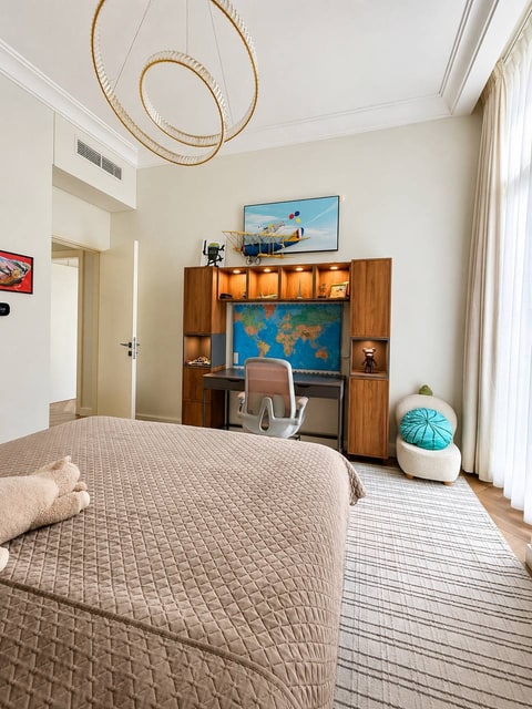 Children’s bedroom with a wooden desk, model aeroplane and world map