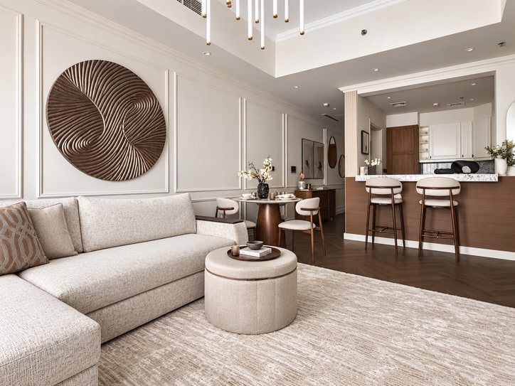 Soft neutral living room with a sculptural wooden wall piece and an open kitchen