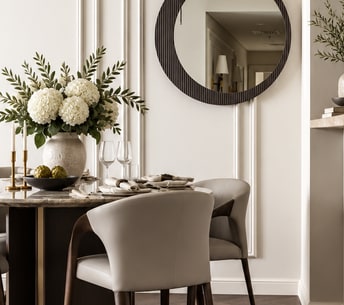 Elegant dining area with a round mirror and sculptural lighting